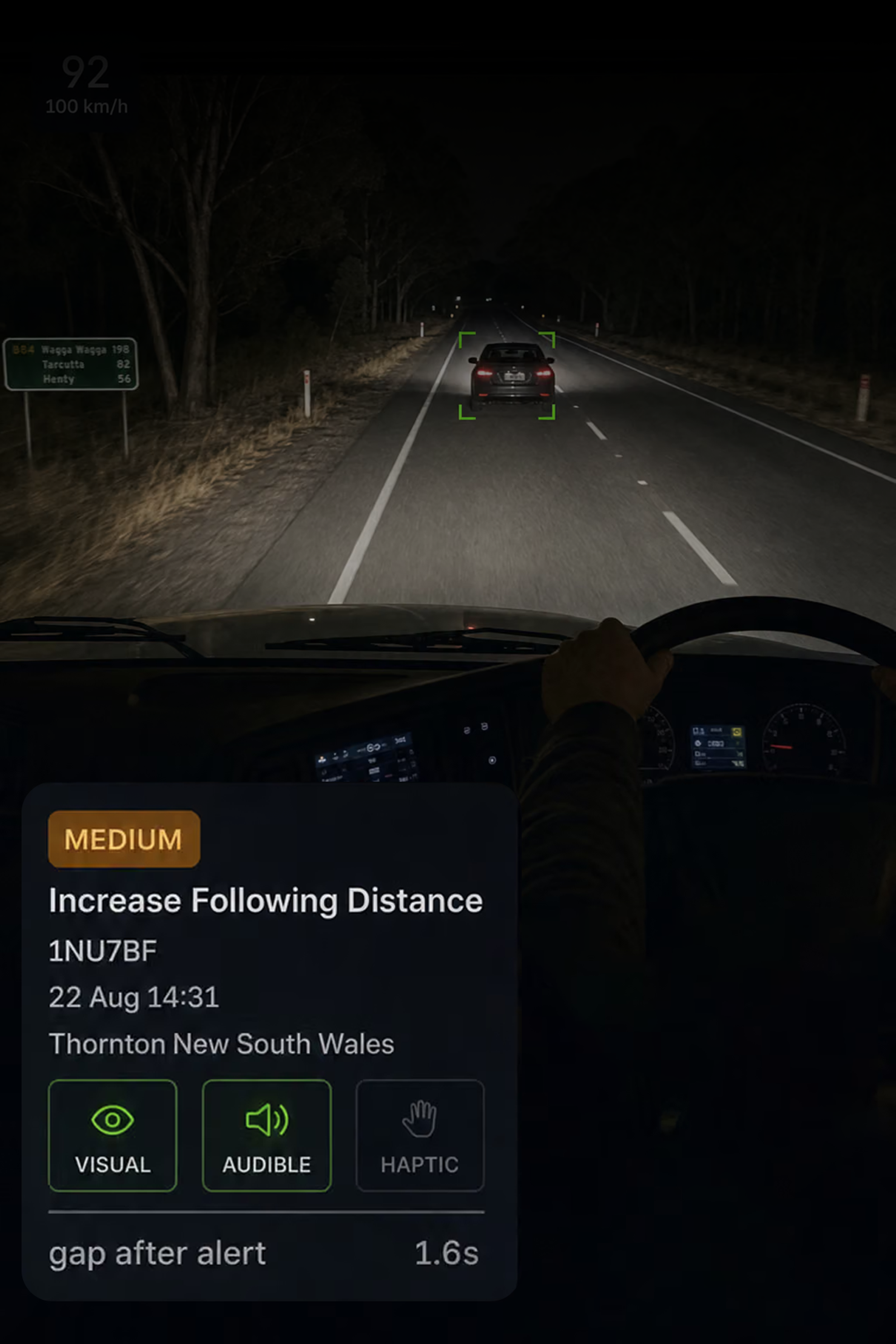 Photograph: a truck cab interior with the in-cab display lit on the dash. Portrait 3:4, dark and cool, room at the top for a heading, no text in the artwork.