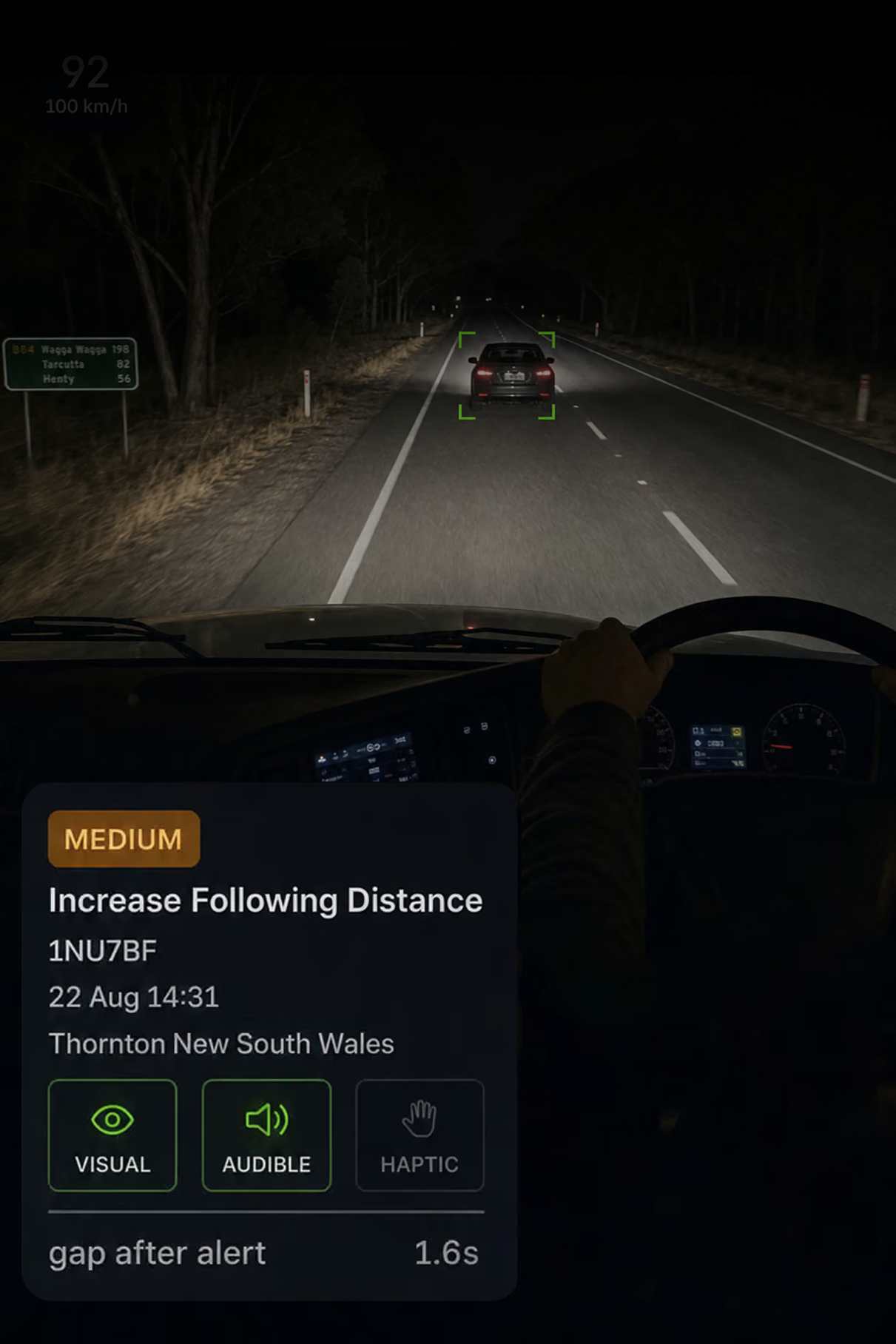 Photograph: a truck cab interior with the in-cab display lit on the dash. Portrait 3:4, dark and cool, room at the top for a heading, no text in the artwork.
