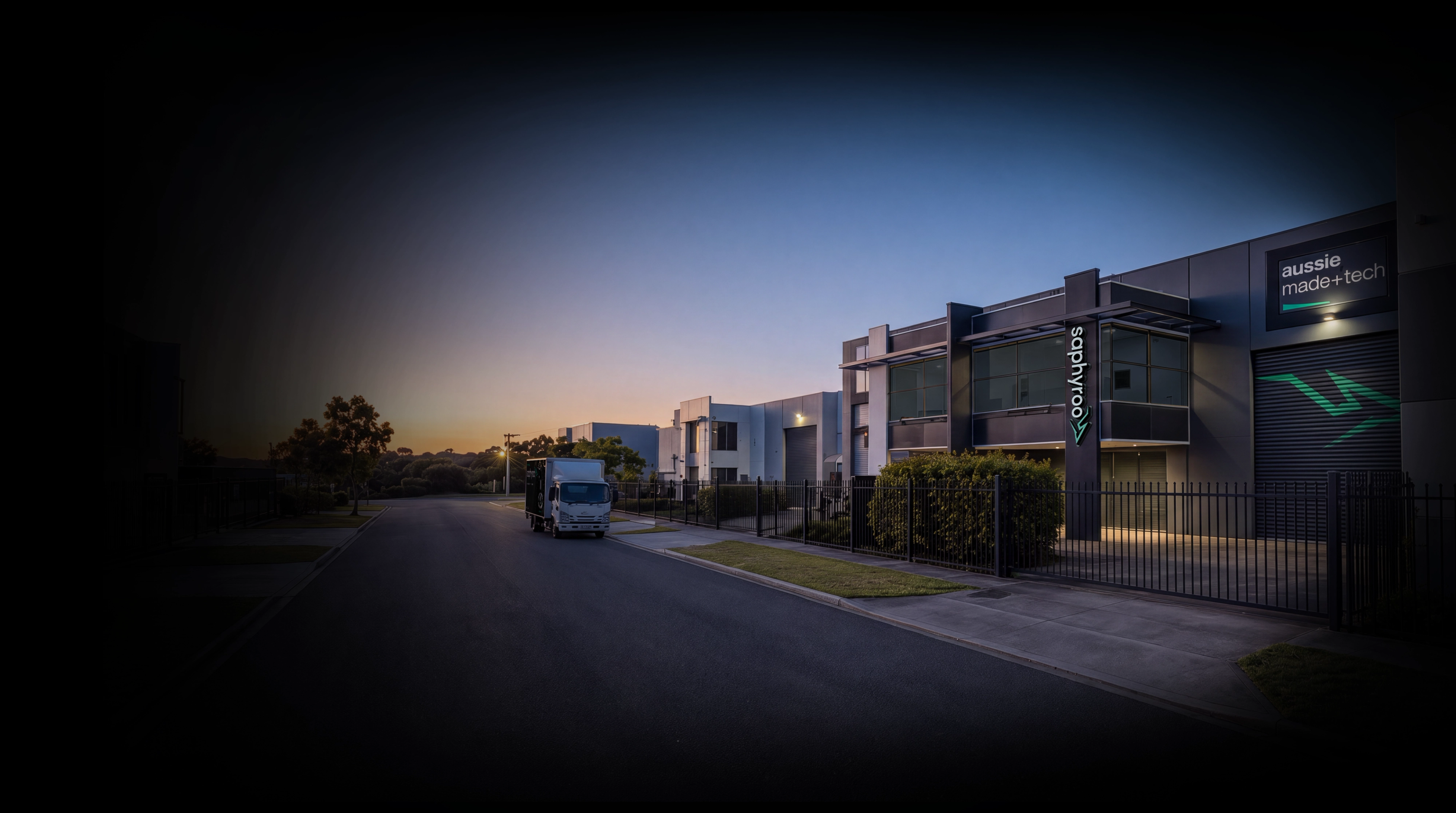 The Saphyroo building at dusk, a delivery truck on the road outside