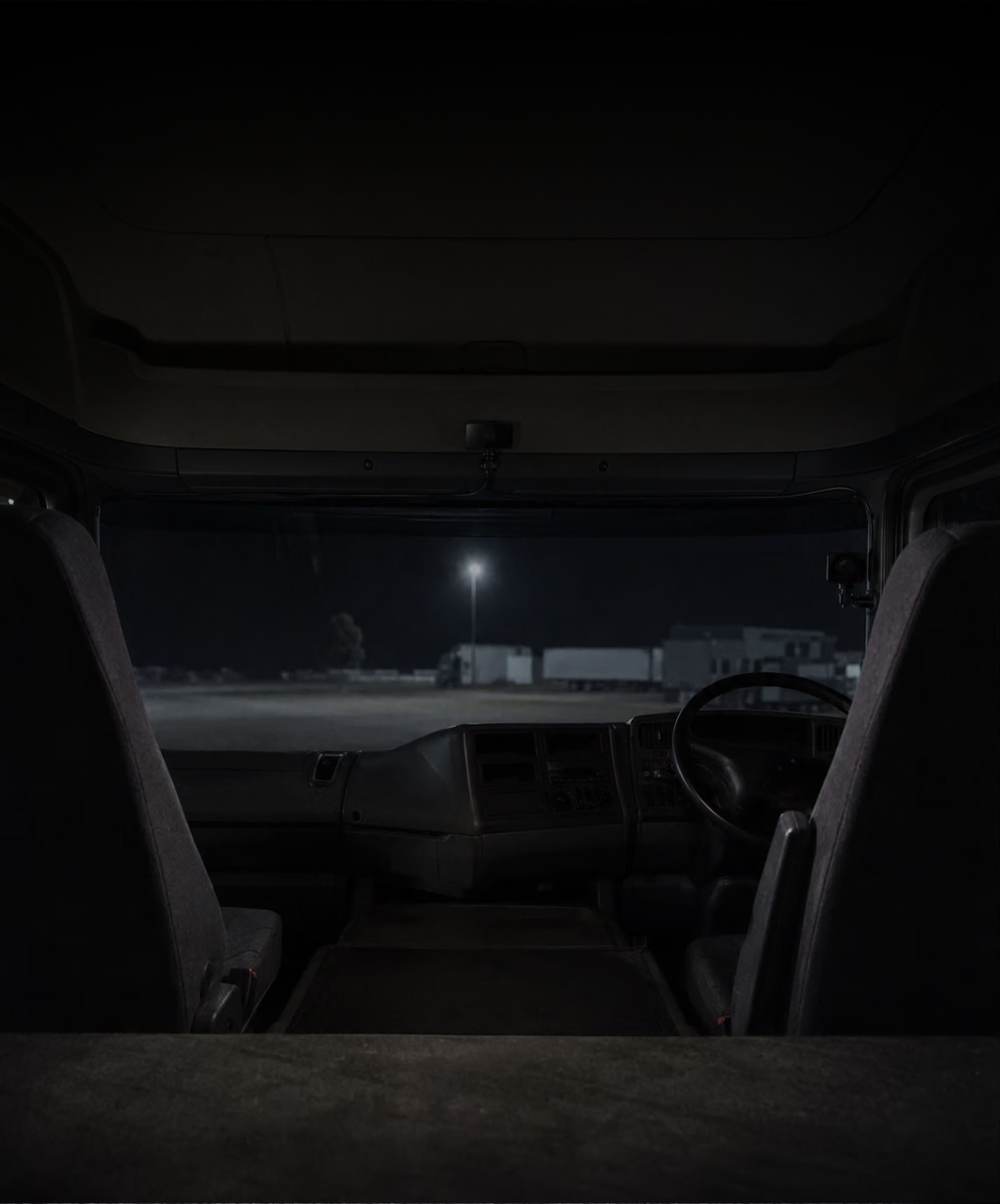 Photograph: a cab interior at night, camera mounted at the screen. Dark and cool, room at the top, no text in the artwork.