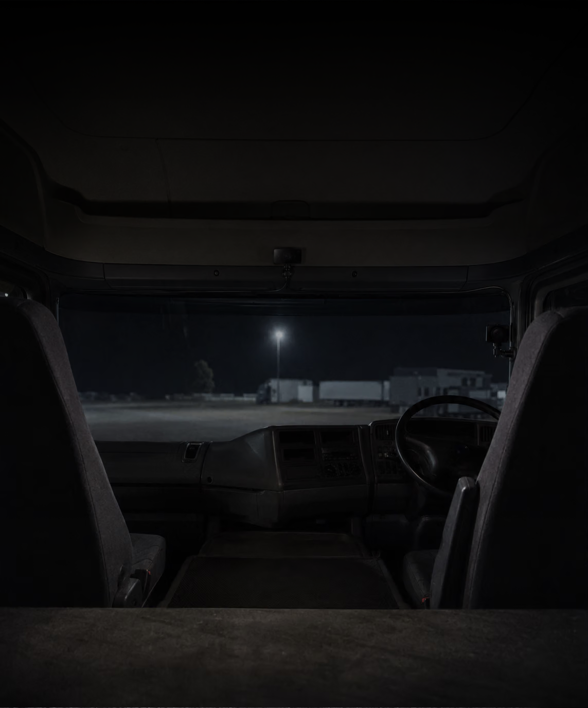Photograph: a cab interior at night, camera mounted at the screen. Dark and cool, room at the top, no text in the artwork.