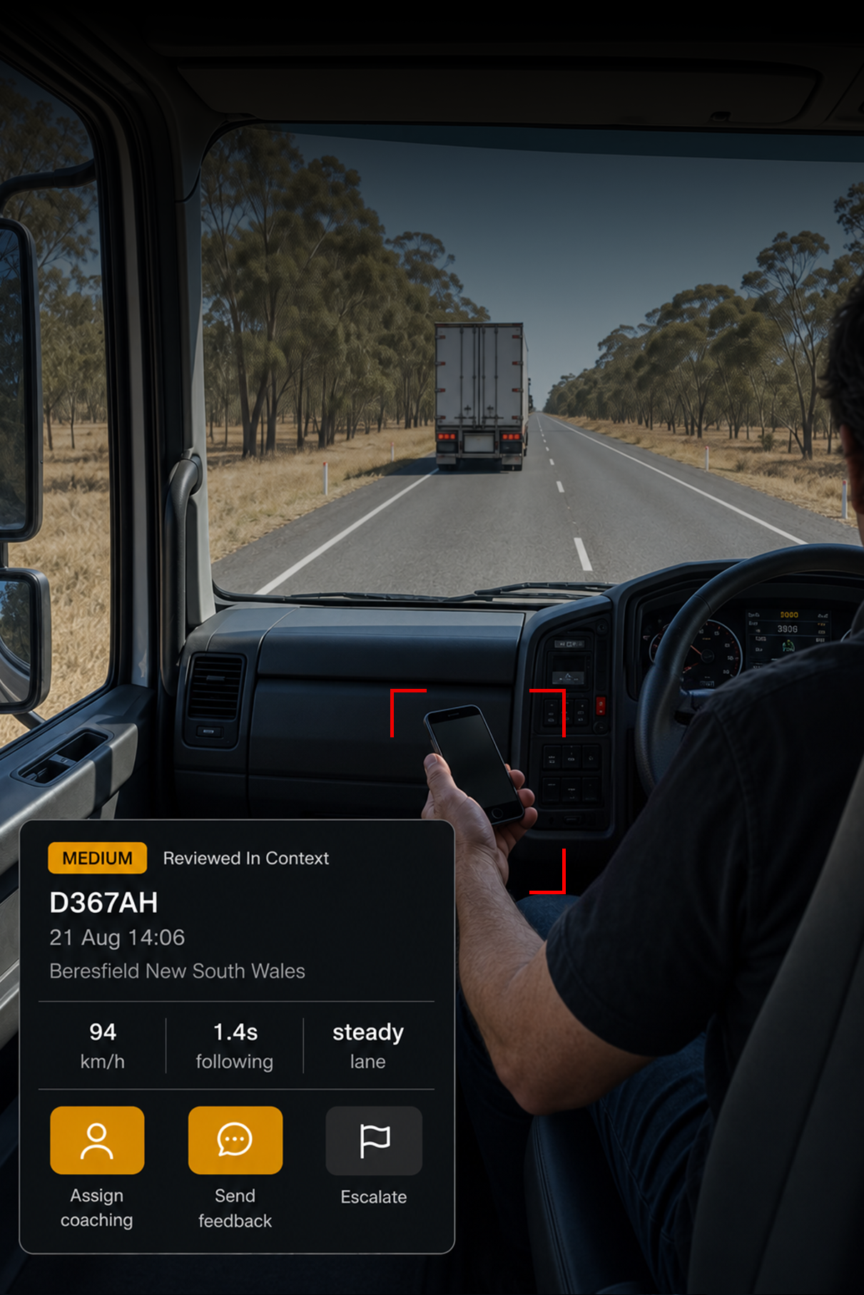 Photograph: a manager at a desk reviewing in-cab footage on a monitor, screen content not legible. Portrait 3:4, dark and cool, room at the top for a heading, no text in the artwork.